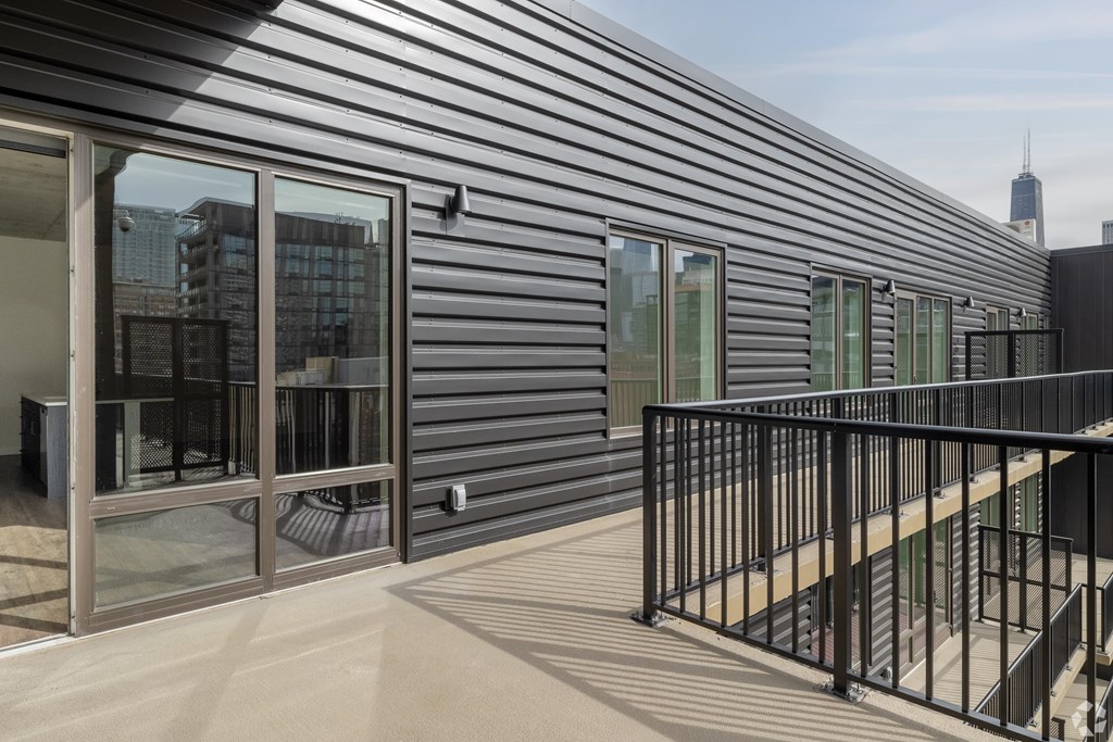 A modern house with a balcony and a view of the city.