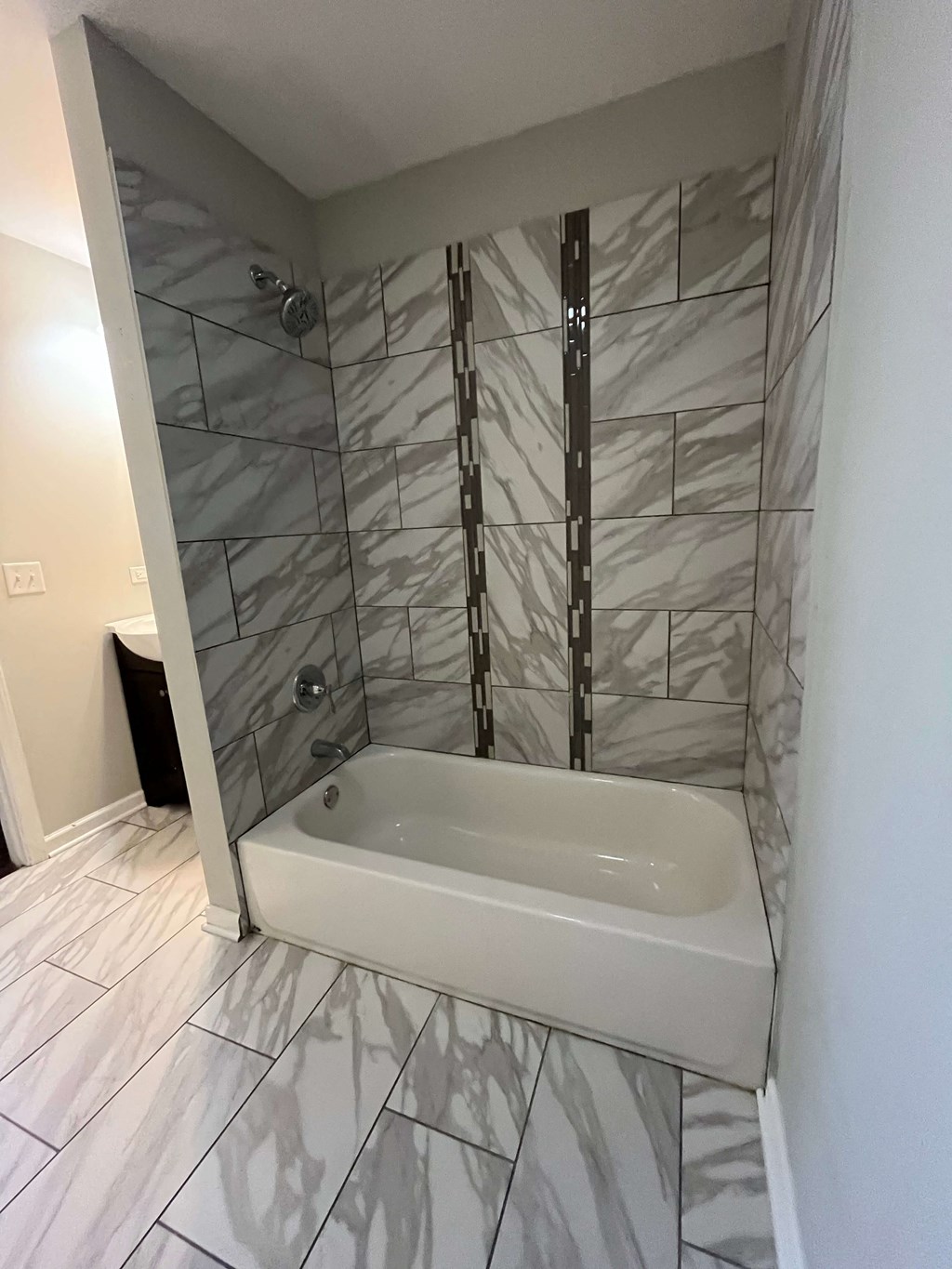 a bathroom with a shower and a tub in it