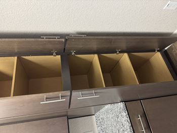 A kitchen with a stainless steel drawer pull.