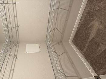 A white square is in the middle of a room with a brown carpet.