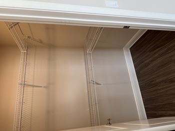 A modern bathroom with a shower and a wooden wall.