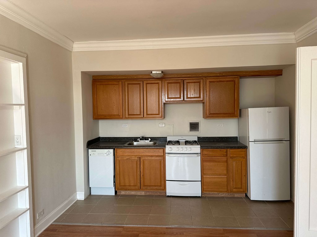 a kitchen with white appliances and wooden cabinets