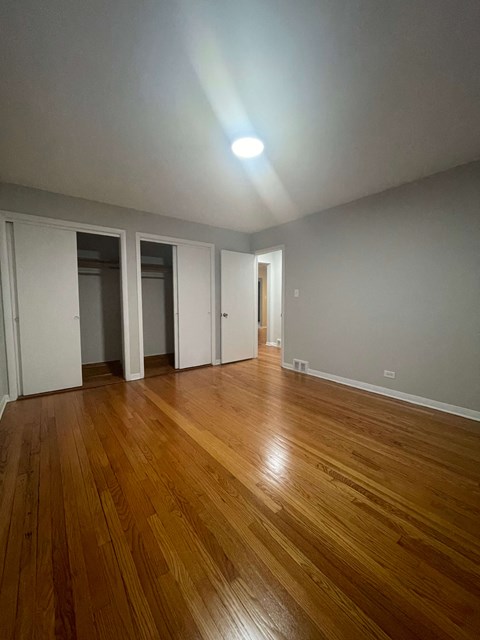 A room with wooden floors and white walls.