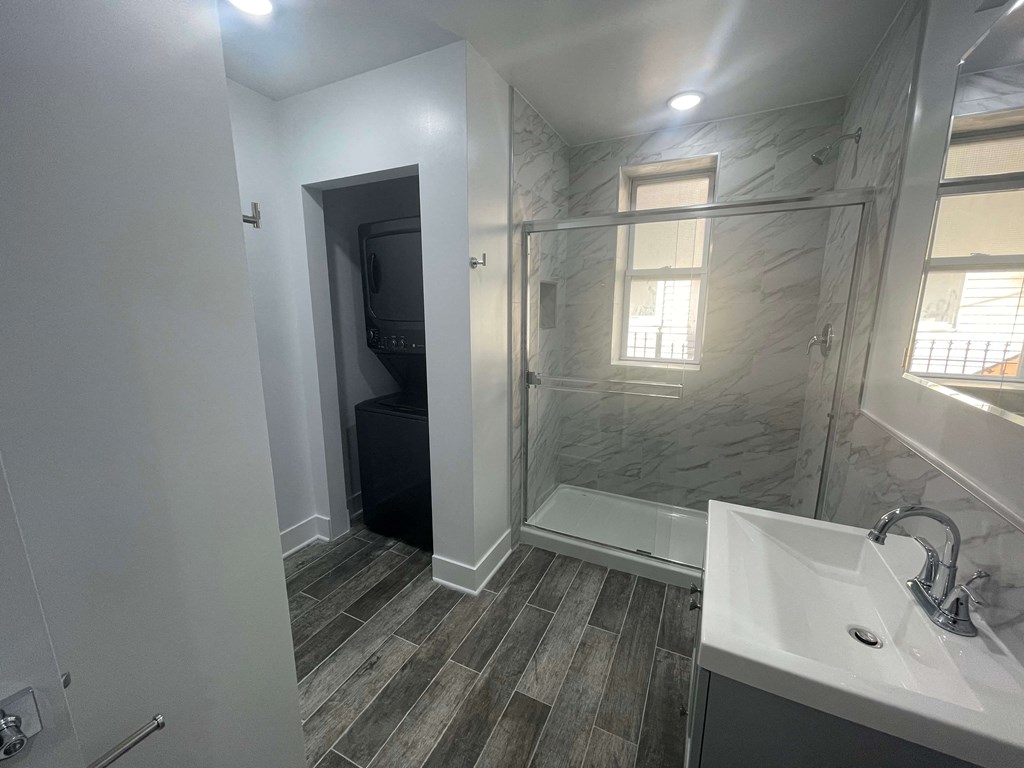 a bathroom with a shower and a sink