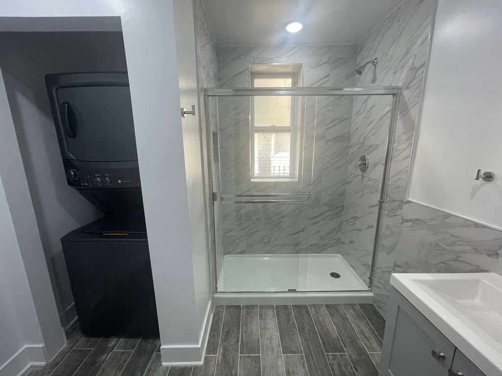 a small bathroom with a shower and a tv in it