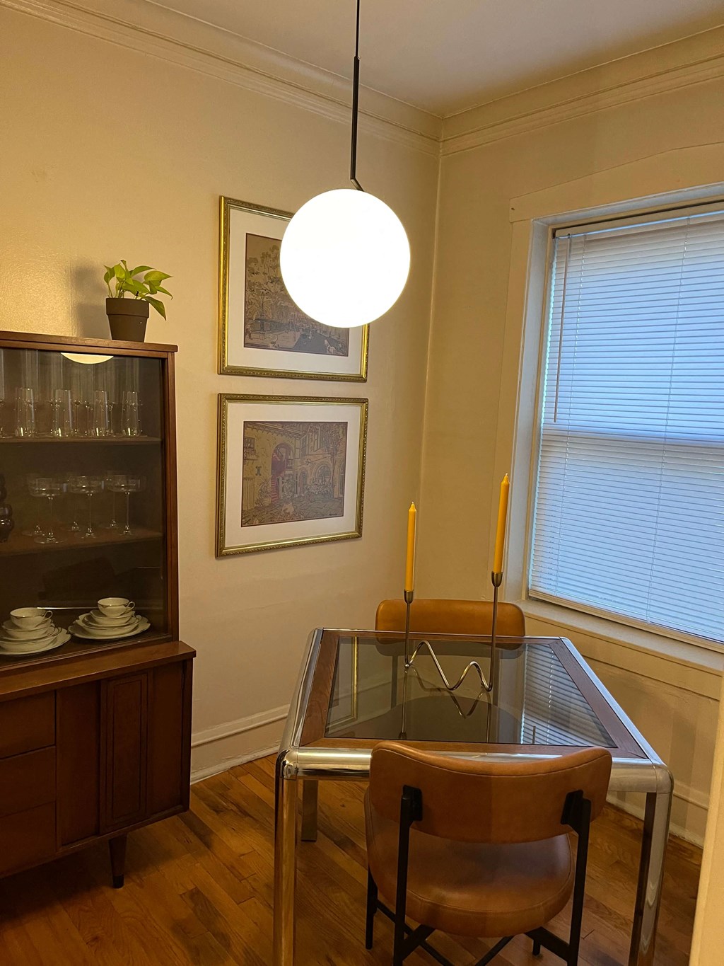 a dining room with a glass table and chairs