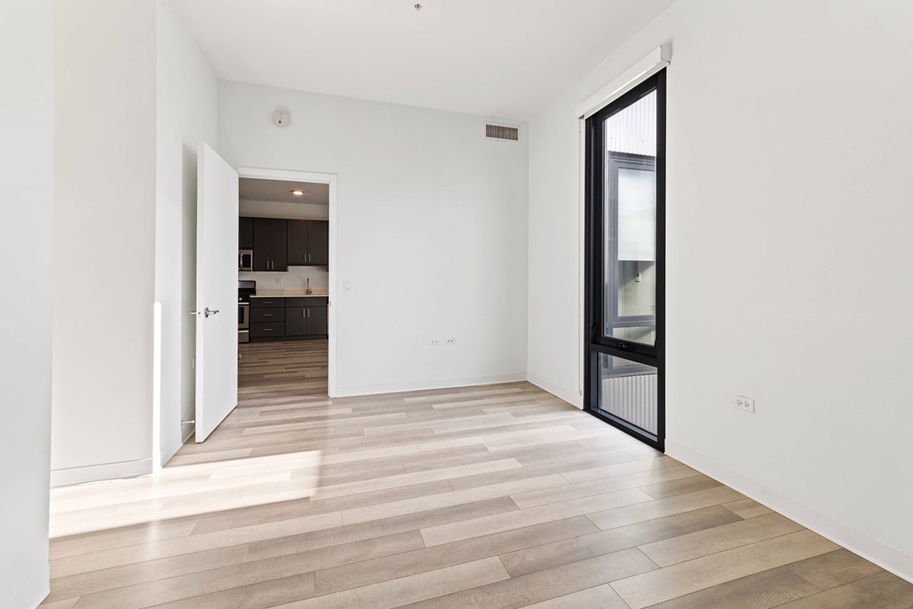 A room with a wooden floor and white walls.