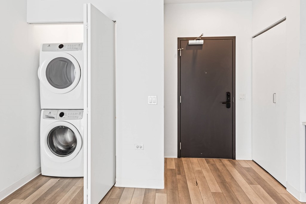 A white washing machine and dryer in a small room.
