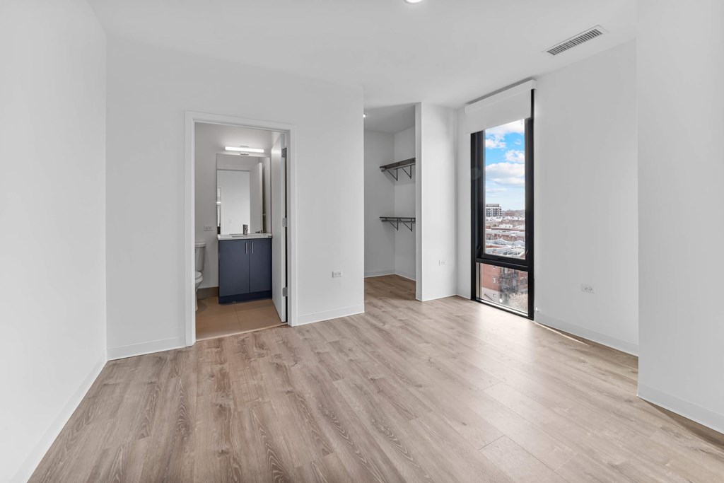 A room with a wooden floor and white walls.