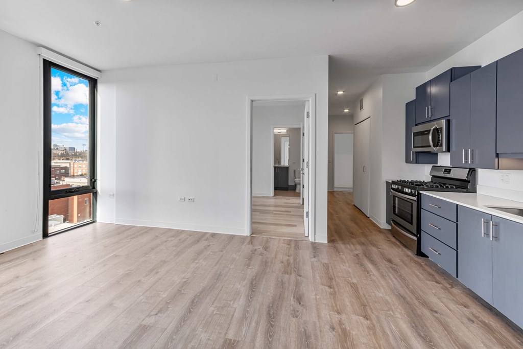 A spacious kitchen with a view of the city outside the window.
