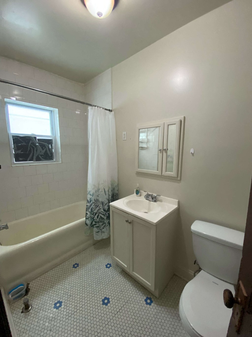 a bathroom with a toilet and a sink and a bath tub