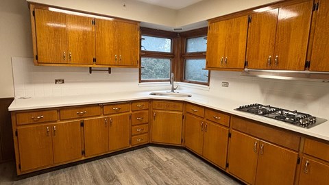 A kitchen with wooden cabinets and a white countertop.