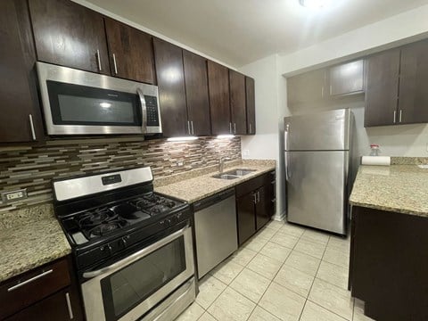 a kitchen with stainless steel appliances and granite countertops