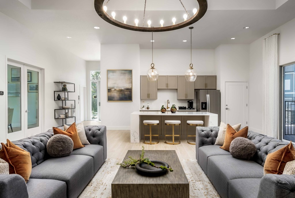 A modern living room with grey sofas and a wooden coffee table.
