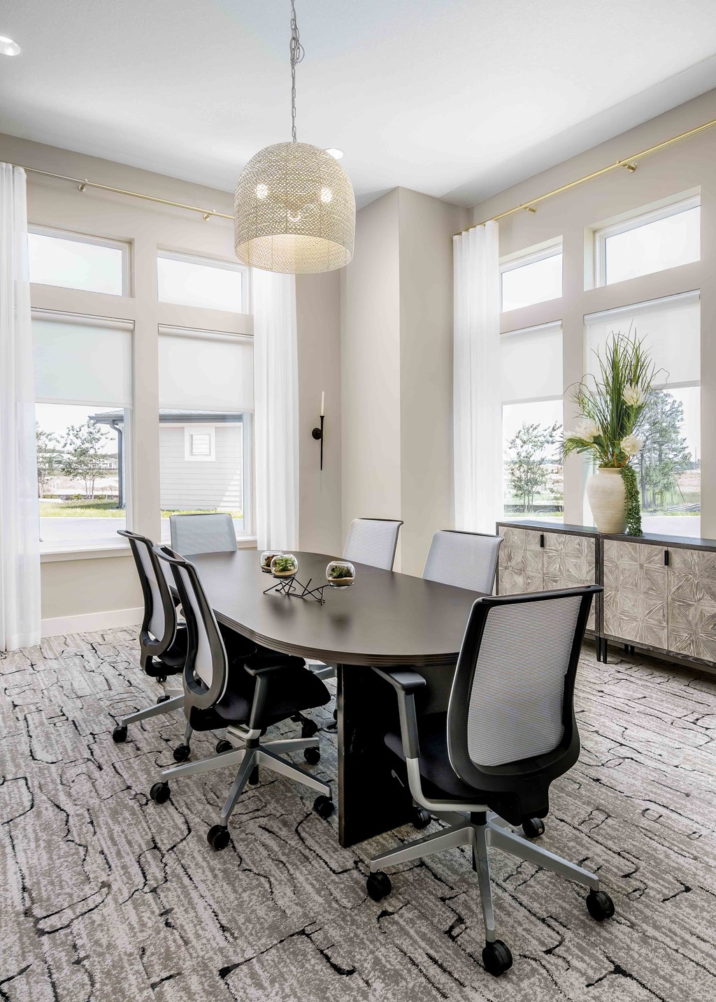 A conference room with a table and chairs.