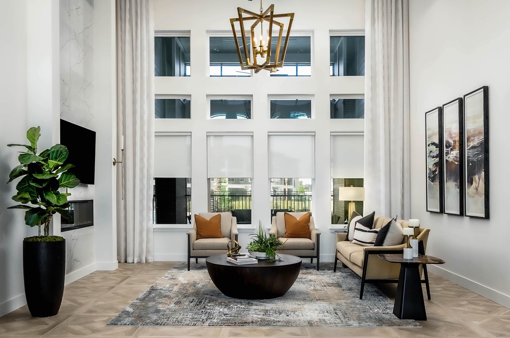 A living room with a large window, a sofa, a coffee table, and a TV.