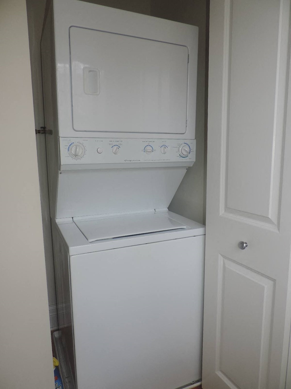 a white washer and dryer in a white closet