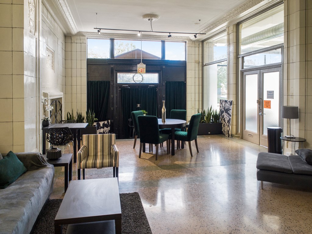 a large living room with a table and chairs