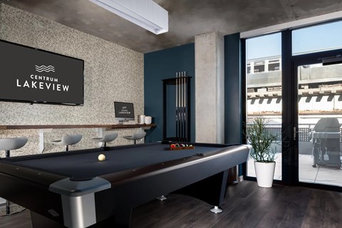 A pool table in a room with a sign that says "Centrum Lakeview".