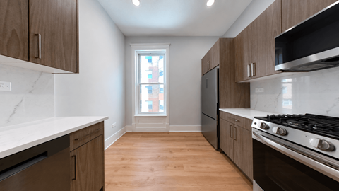 A kitchen with wooden cabinets and a stove top oven.