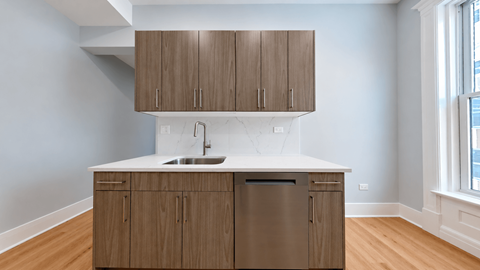 A kitchen with wooden cabinets and a white countertop.