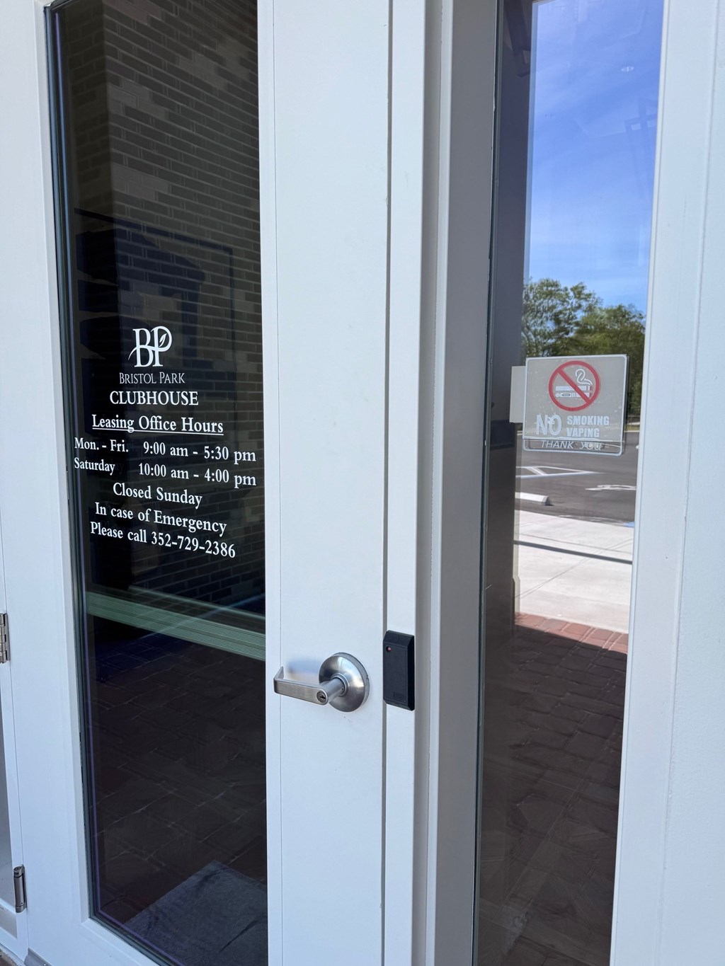 A glass door with a sign that says No smoking or vaping