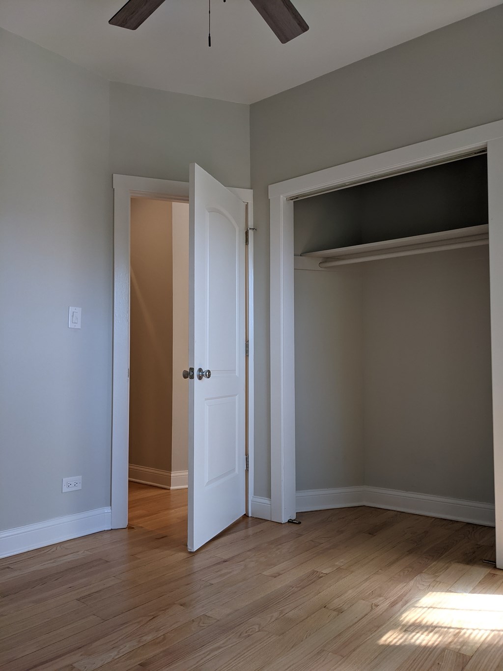 A room with a white door and a brown door.