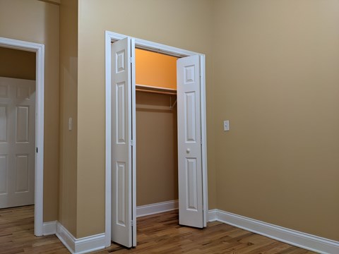 A room with a white door and a brown wall.