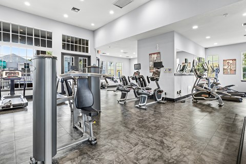 A gym with a variety of exercise equipment.