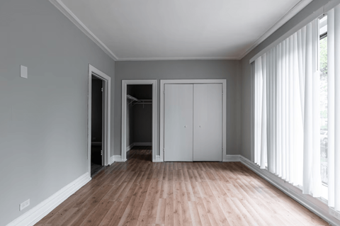 A room with a wooden floor and white walls.