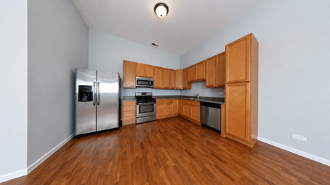 A kitchen with wooden cabinets and stainless steel appliances.