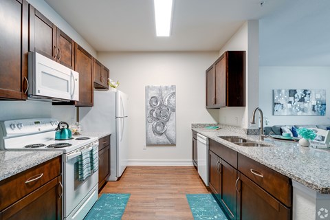 A kitchen with a white fridge and a white stove.