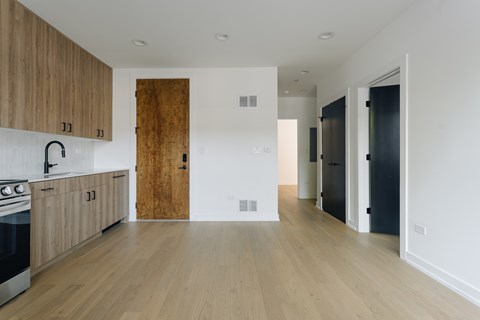 A kitchen with wooden cabinets and a black oven.