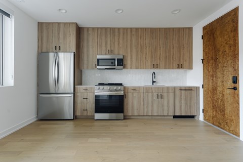 A kitchen with wooden cabinets and stainless steel appliances.