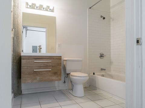 a bathroom with a toilet and a sink and a tub
