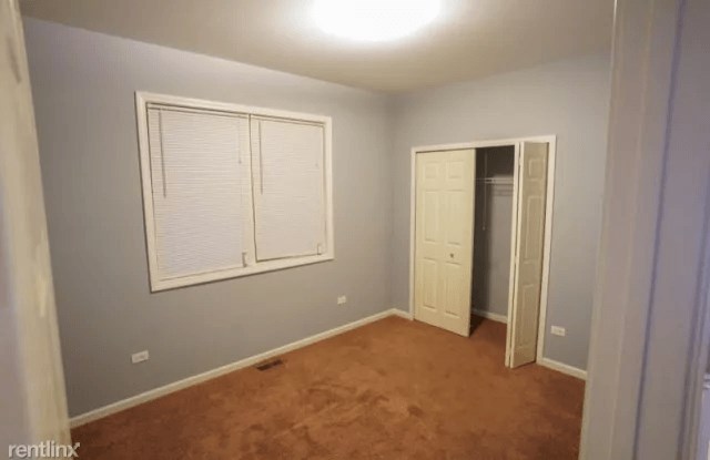 a empty room with a window and a closet