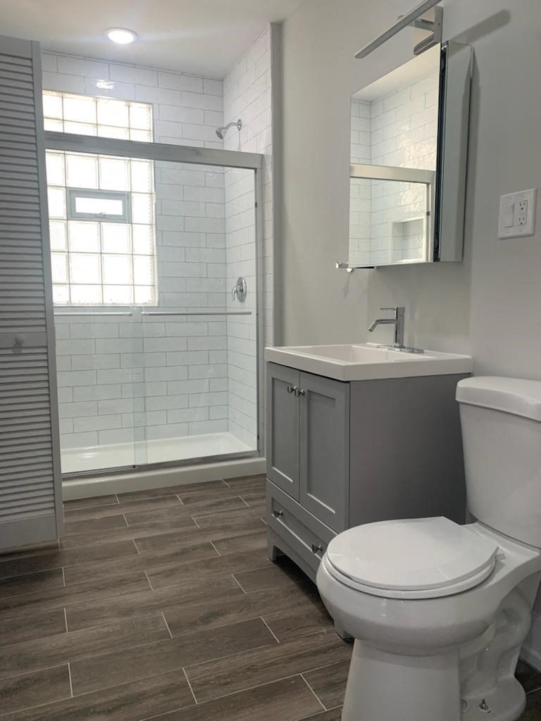a bathroom with a toilet and a sink and a shower