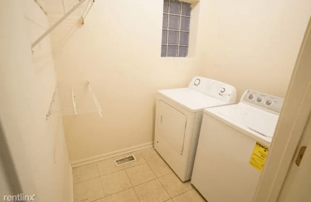 a laundry room with a washer and dryer in it
