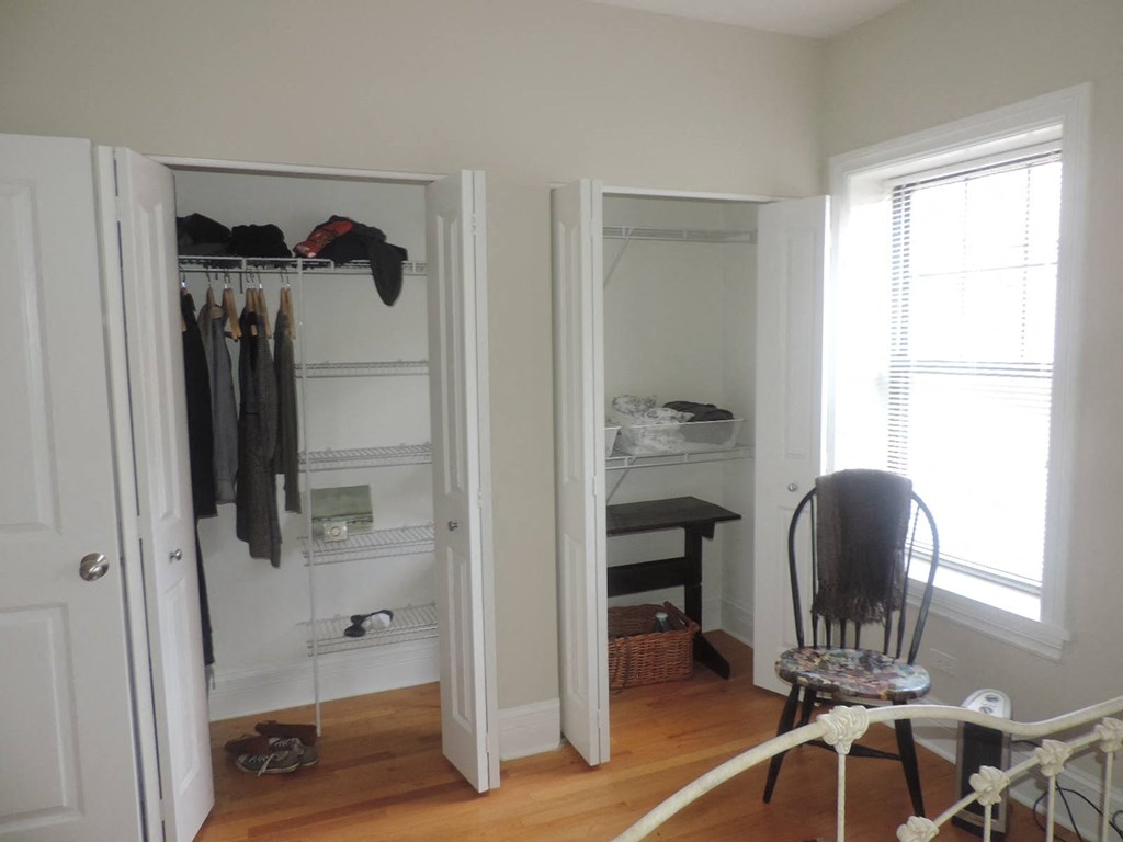 a room with a closet and a chair in it