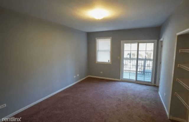 an empty living room with a door to a patio