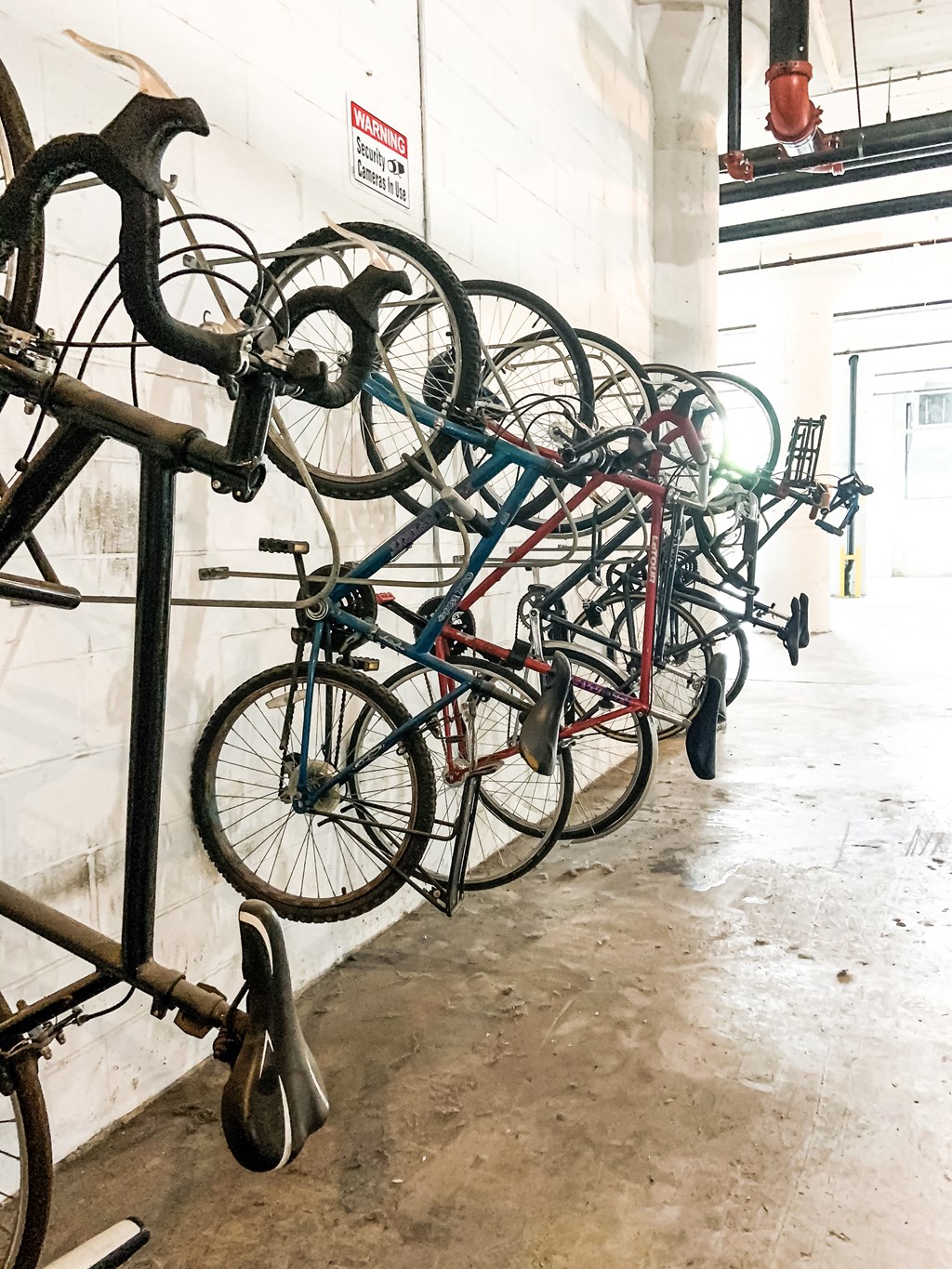 a row of bikes parked on a rack in a building
