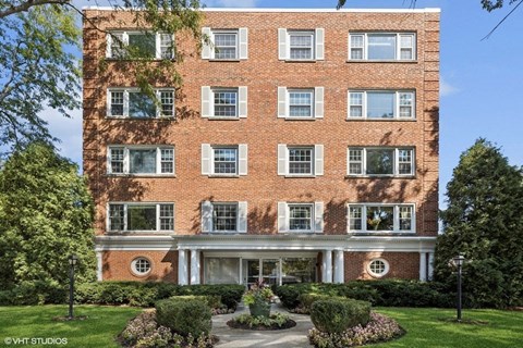 A red brick building with a white entrance and windows.