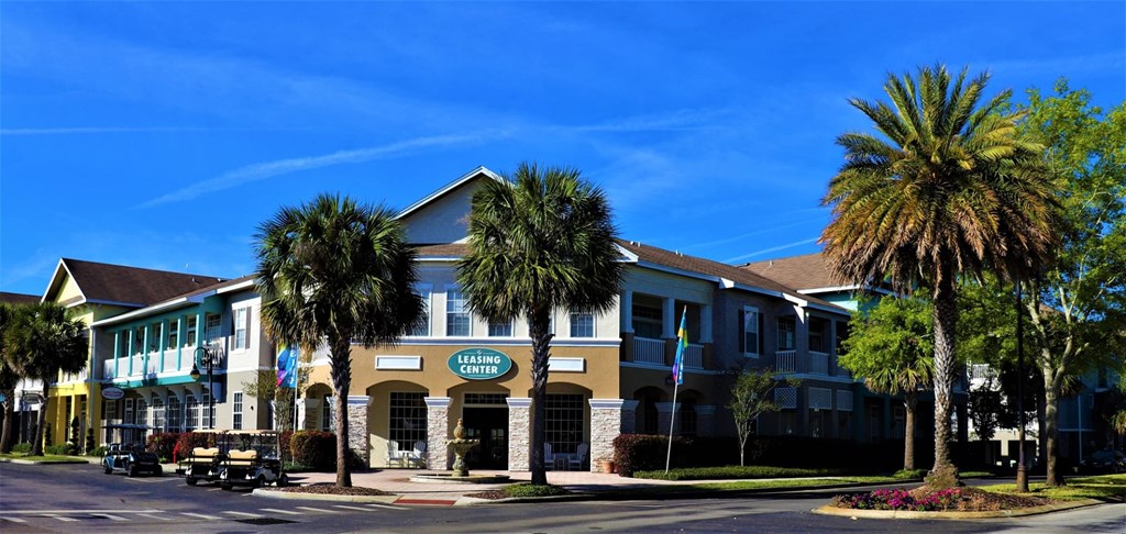 A building with a sign that says "Living Center" is surrounded by palm trees.