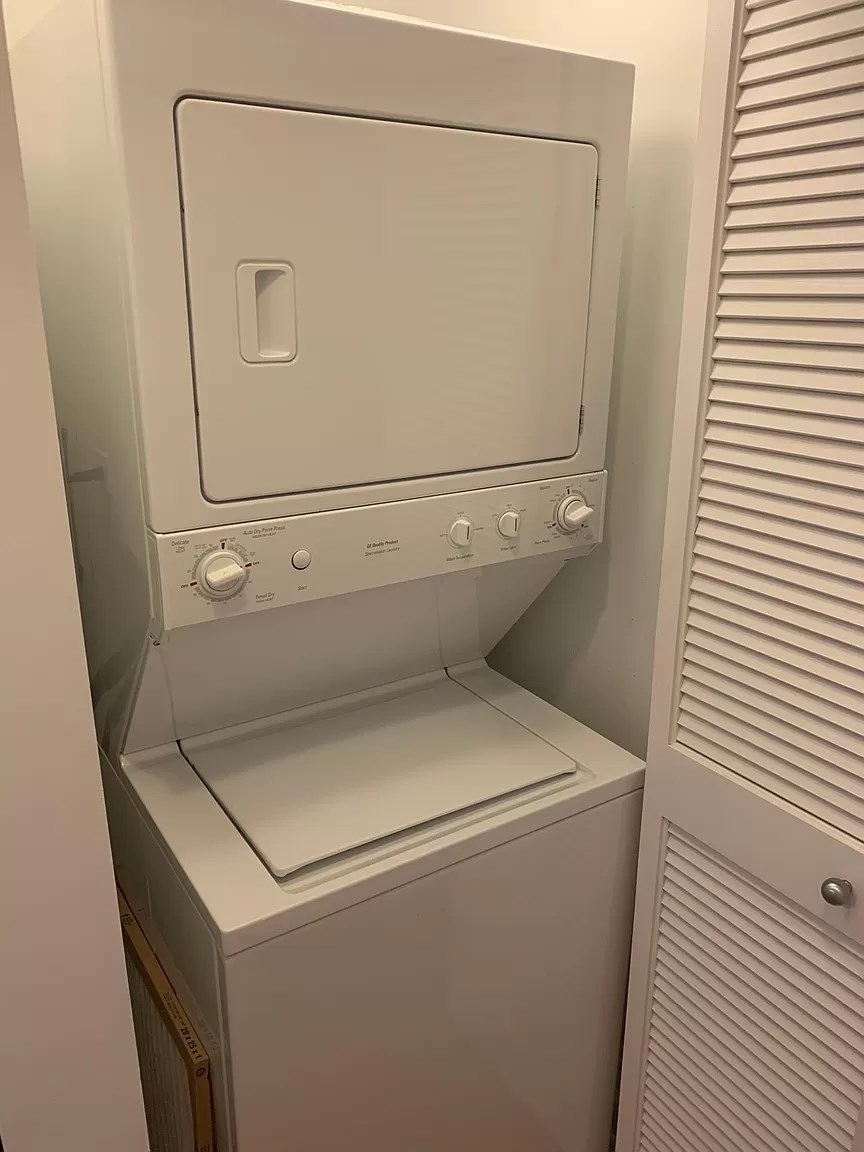 a white washer and dryer in a closet