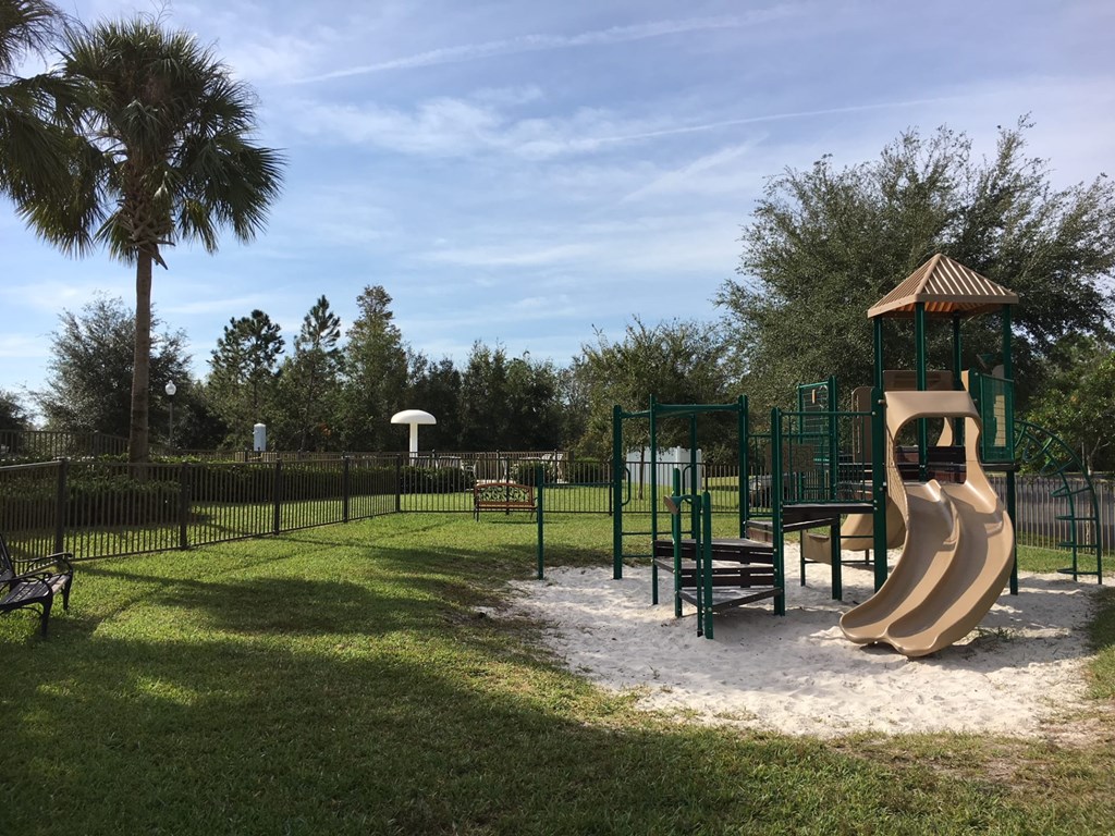 A playground with a slide and a wooden structure.