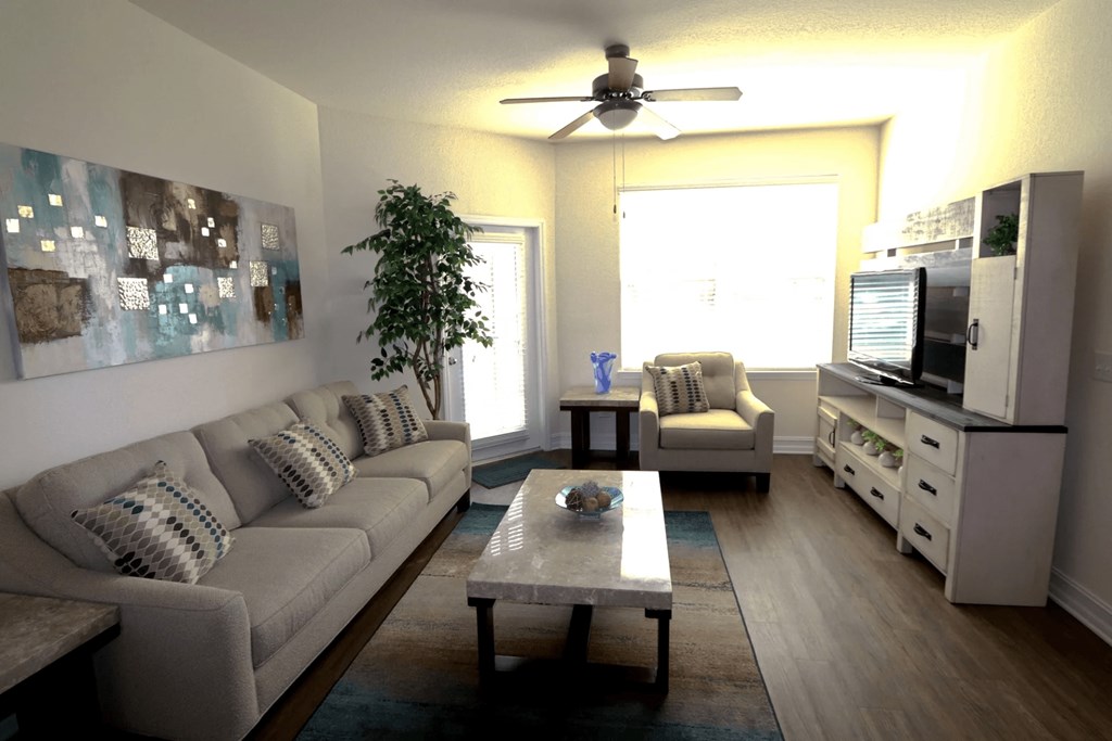 A living room with a grey couch and a coffee table.