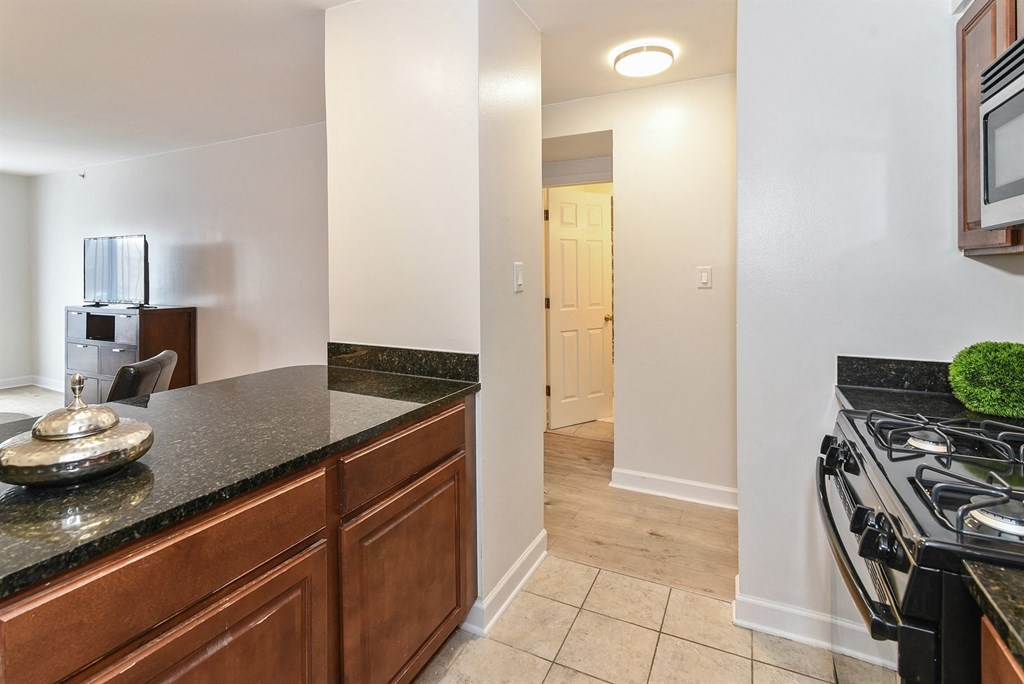 the view of the kitchen from the dining area with the entrance to the living room