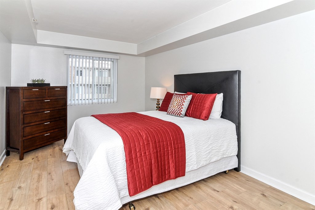 a bedroom with a bed and a dresser