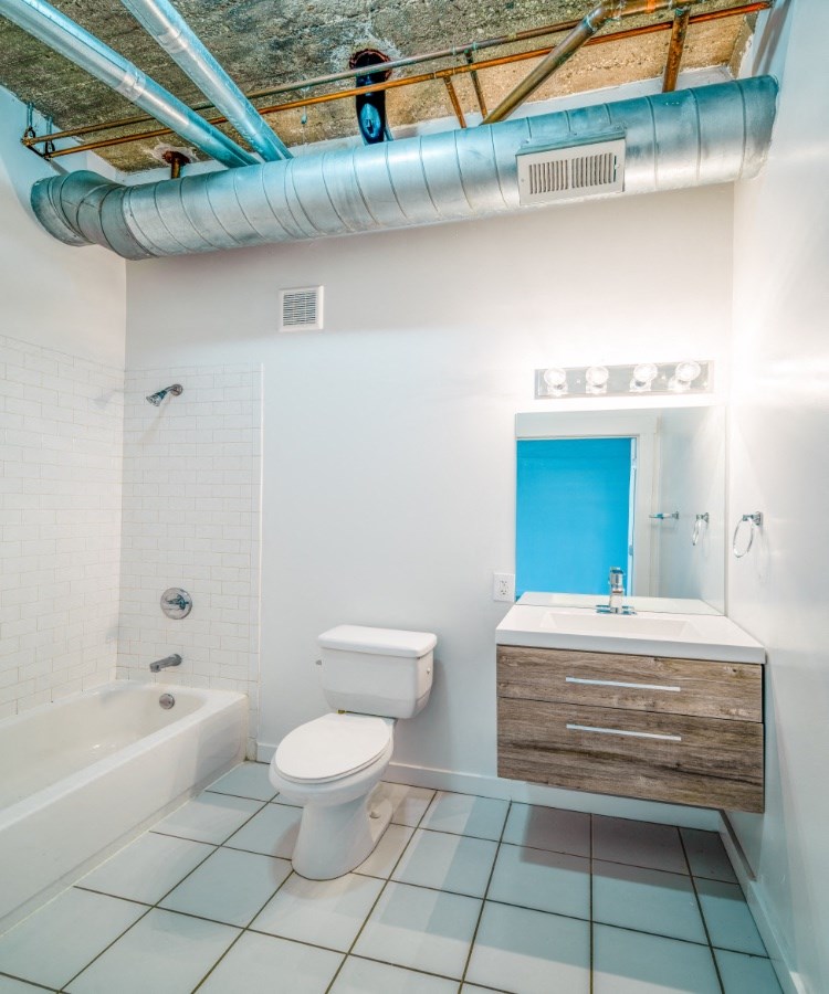 a bathroom with a toilet and a sink and a tub