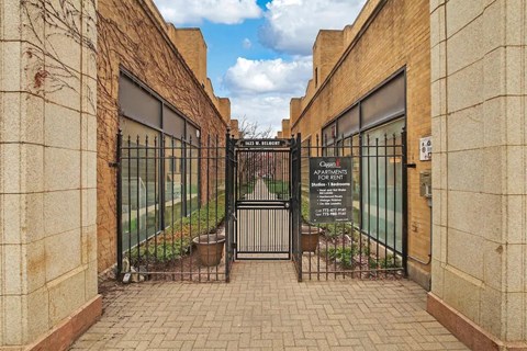 a gate with a sign on it in front of a building